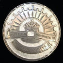 Silver Australian Rising Sun design imbedded in a white enamel background. Hallmarked silver & maker marked what appears to be "FRG", but hard to read.