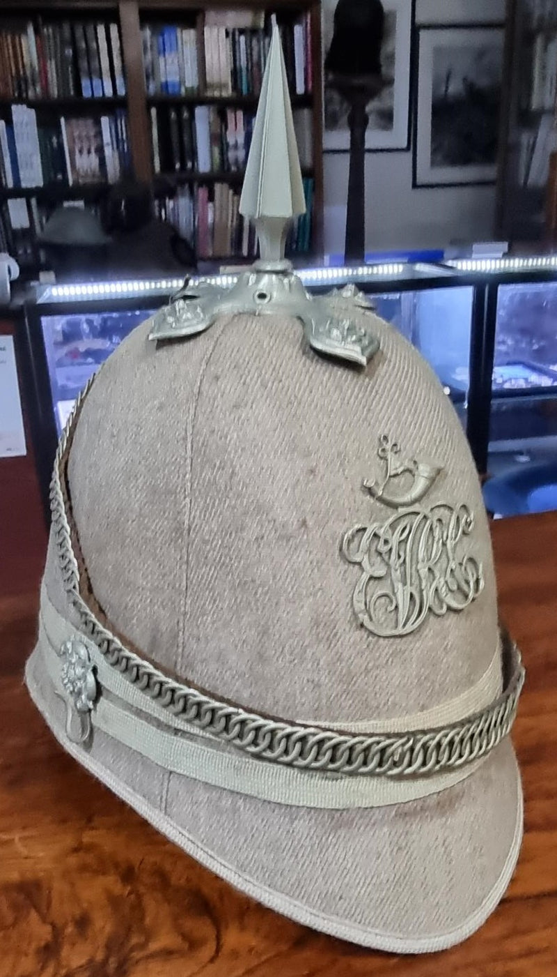 An 1878 pattern Gey Cloth helmet of the Eaton Volunteer Rifle Corps.