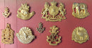 A Selection of 9 KINGS COLONIAL INSIGNIA. A very fine carded display of unissued examples. All with original Gilt. This collection of badges comes from the original J.R. Gaunt and Son Ltd - SOLD