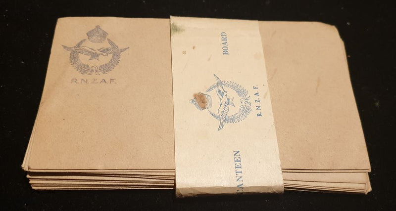 Fifteen R.N.Z.A.F. envelopes produced and sold by the Canteen Board for airmen to purchase to write home with. Still will paper tag to hold bundle together intact and also marked R.N.Z.A.F.  with badge (Marked Canteen Board).