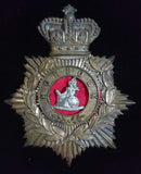 An 1881-1901 Norfolk Regiment Helmet Plate in brass, laurel wreath surrounds the voided centre, the figure of Britannia seated is white metal and backed by red felt.