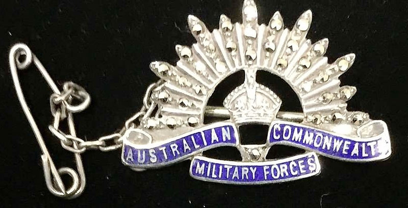 Void Australian Rising Sun design not marked but quality construction with stones covering the Sun's ray and scrolls in blue enamel.  Collar badge size with safety chain.