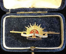 Traditional Rising Sun design marked 9 CT with detailed enamel in its jewellers case.
