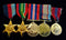 Group of Five:1939/45 Star, Pacific Star, War Medal, Australian Service Medal 39/45 and QE11 Coronation medal. First four medals correctly impressed to V145395 P. R. SMITH. Coronation medal un-named as issued